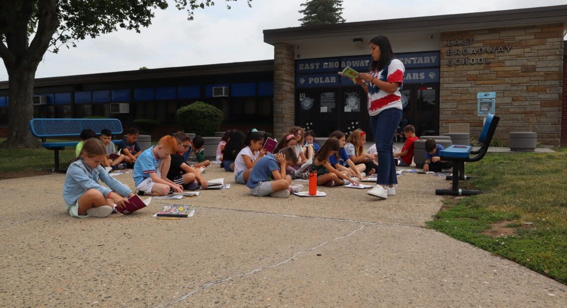 East Broadway Students Read Together In The Sunshine
