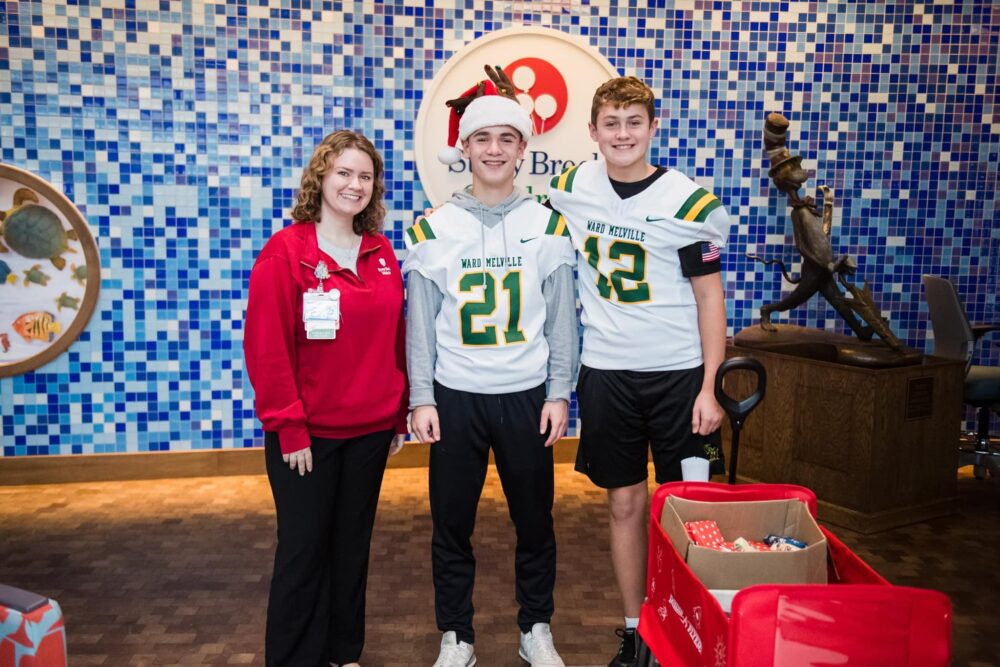 Festive Off The Field: Football Team Makes Donation To Stony Brook Children&#8217;s Hospital